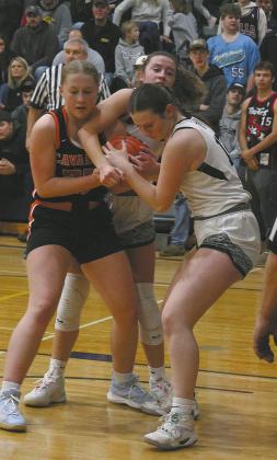 Cavalier's Katy Jensen fights for control of the ball against DVE's Jaelyn Johnson and Ingrid Myrdal. Photo by Jamie Rarick