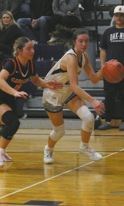DVE senior Jaelyn Johnson drives toward the basket past Cavalier junior Colbie Furstenau. Photo by Jamie Rarick