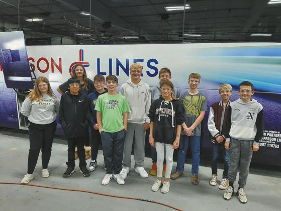 North Border Pembina students pose in front of a bus being built at the Motorcoach Industries plant in Pembina. Submitted photo