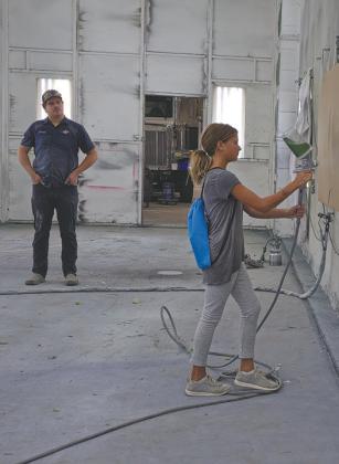 Although they weren’t using actual paint, students visiting CVR Industries in Neche were given the chance to operate the equipment in the paint room. Submitted photo