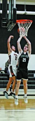 Carter Oberg goes for the shot past Warrior defender Monty Redfox, Jr. Photo by Jamie Rarick.