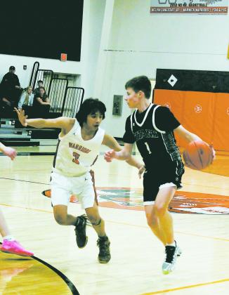 Drew Passa looks to move the ball past Warrior defender Aiden Black. Photo by Jamie Rarick.