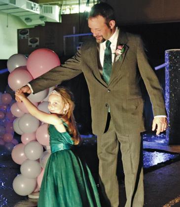 Brooks Stellon give daughter Amelia a twirl during the Grand March for the Daddy Daughter Dance. VNV Photo by Lesa Van Camp