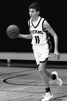 Quinn Passa brings the ball up the court in the closing moments of the game against North Border. Photo by Lyle Van Camp.