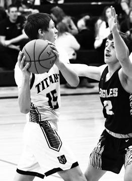 Jayse Gullickson looks for an open teammate in action against the Eagles. Photo by Lyle Van Camp.