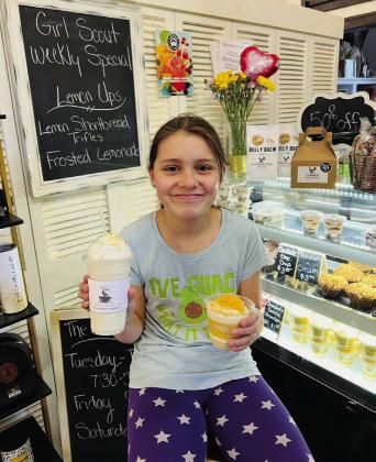 Girl Scout Amelia Ripple poses at The Crooked Halo: Coffee Shop &amp;amp; Bakery with signature lemon drinks made from one of the Girl Scout cookie flavors. Submitted photo.