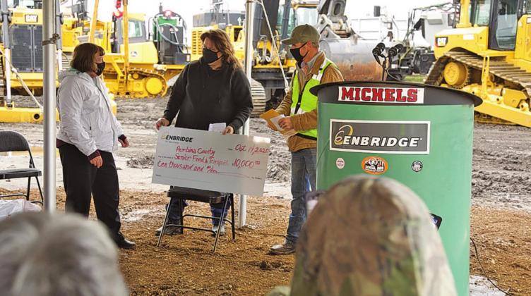 Pictured above Sally Kliniske left is presented with a donation for Pembina County Meals and Transportation by Enbridge last Wednesday afternoon. Photo submitted by Enbridge