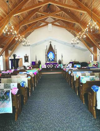 the interior of the sanctuary with donated and refurbished pews, alter, pulpit, and railings