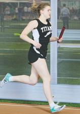 Greta Burrell ran one leg of the girls 4 by 800 relay. Photo by Lyle Van Camp.