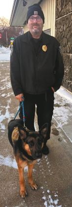 Freeway the “community dog” and his dad Officer Mattice. Photo by Christine Jensen