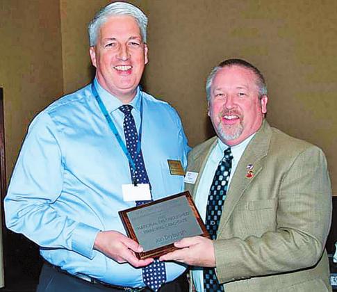 Pictured above left to right: Lay Pastor Jon Dryburgh being presented with the award for Regional Principal of the year from Paul Wenger in Bismarck. Photo submitted