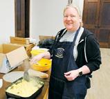 Miranda Arens cooking up some eggs at the EMS breakfast benefit. Photo by Rob Boll.