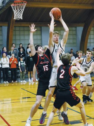 Under heavy defense from Midway-Minto's Andrew Riske and Elijah Robinson, DVE's Jack Langerud looks to save the ball. Photo by Jamie Rarick