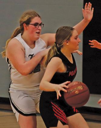 Isabella Douville guards a Polar Bear near their bucket in Tuesday nights matchup in Drayton. VNV Photo by Lesa Van Camp