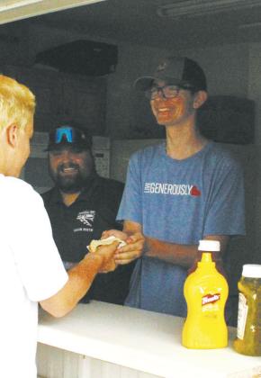 Jonah Rarick and Raven Smith helped serve concessions at Schumacher Park on Friday as a fundraiser for the Bomber football team.