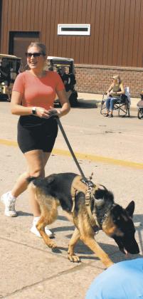 Rylee Maurstad and K-9 officer Freeway visited with the crowd during Saturday's parade. Photo by Jamie Rarick