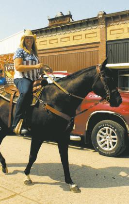 Genafay Pokrzywinski rode down Main Street during Saturday's Riverfest parade. Photo by Jamie Rarick