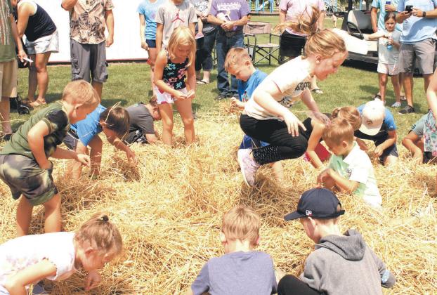 Kids had a blast searching through piles of hay for treasure during Koda Bank's coin scramble, held Saturday at Schumacher Park. Photo by Jamie Rarick