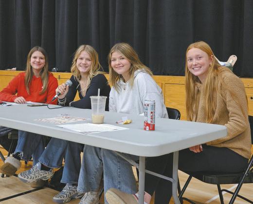 Prom committee members Violet Hoyles, Alyssa Hoyles, Alyvia Quibell, and Peyton Larson assisted with calling numbers during turkey bingo on Sunday evening. Photo by Jamie Rarick.