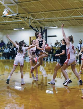 Leaping in the air, DVE senior Brooke Gullickson tries to save the ball from North Star defenders. Photo by Jamie Rarick