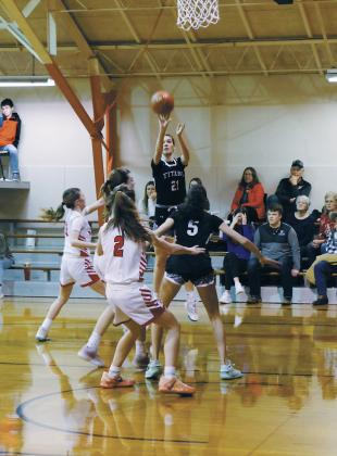 DVE senior Elizabeth Fedje goes for three during Friday's game in Starkweather. Photo by Jamie Rarick