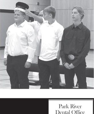 Mr. Babinski places the crown on 2023 Homecoming King Bryce Wimpfheimer while Grant Vold and Gavin Ryan look on. Photo by Lyle Van Camp.
