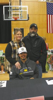 Juan Nevarro, with his parents representing the Army National Guard at Senior Signing Day at DPS. Photo by Andrea Johnston