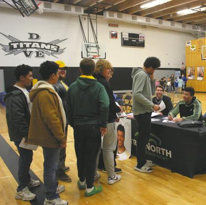 Seniors were available after the speeches to sign autographs for fellow students and attendees. At Daniel De Sousa’s table, students were lined up. Photo by Andrea Johnston