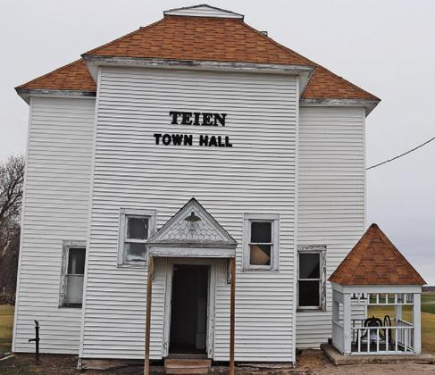 The Teien Town Hall as it currently stands with the bell tower carefully placed on the ground next to the building in an effort to save both the bell and the roof. VNV Photo by Lesa Van Camp