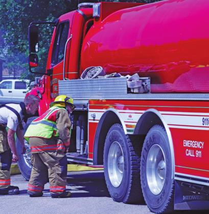 Drayton Volunteer Firemen Grant Schumacher and Bob Merrill check out the water supply at one of the fire trucks. VNV Photo by Lesa Van Camp