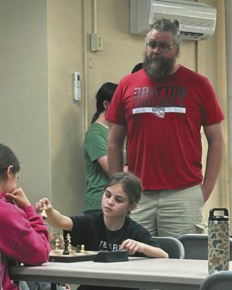 Mr. Foster watches on as Natalie Helm chooses her moves wisely.