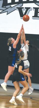 Hatton-Northwood's Elizabeth Pinke goes for the shot as DVE's Elizabeth Fedje leaps for the block. Photo by Jamie Rarick