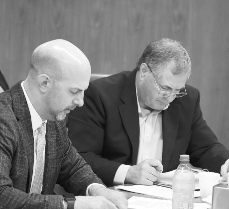 Justin Kringstad, executive director of the North Dakota Pipeline Authority, and Agriculture Commissioner Doug Goehring listen to discussion about two pipeline project proposals during the Aug. 21, 2025, meeting of the North Dakota Industrial Commission. Photo by Mary Steurer/North Dakota Monitor