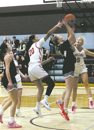 DVE freshman Peyton Larson goes up for the shot against Midway-Minto defenders. Photo by Jamie Rarick
