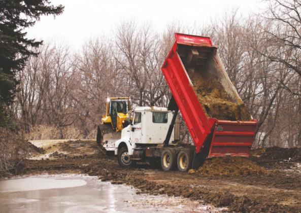 Helm Enterprises began building the temporay dikes here on Monday. Pictured is work near the city water plant Monday afternoon. VNV photo by Lyle Van Camp