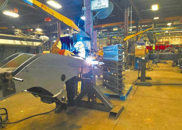 A welder works at a Manitou factory in June 2023 at Madison, South Dakota. Labor shortages in North Dakota and South Dakota could be harbingers of a shortage of young people in coming years. (Photo by Joshua Haiar/South Dakota Searchlight)