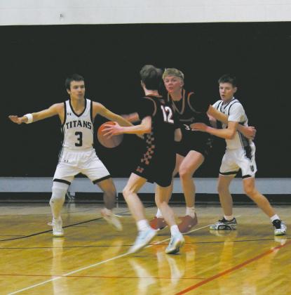 Titan defenders Trenten Bronson-Keena and Drew Passa work to stop the Mustang's play in Drayton Feb. 6. Photo by Jamie Rarick