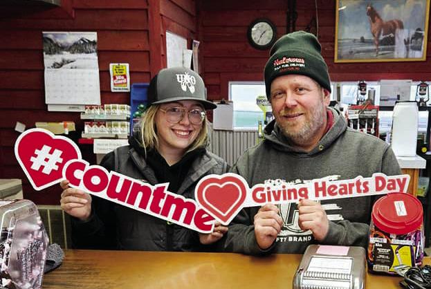 Father-daughter duo Sophie and Dusty Wilson from Halcrows pose for a photo for Giving Hearts Day, Feb. 8.