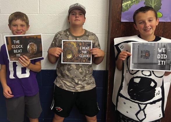 Asher McFarland, Jax Woinarowicz, and Casey Sehrt after solving escape room puzzles.