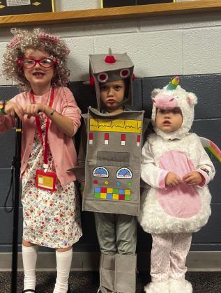 Adelaide, Woodson, and Whitley pose for a photo-op in their Halloween costumes.