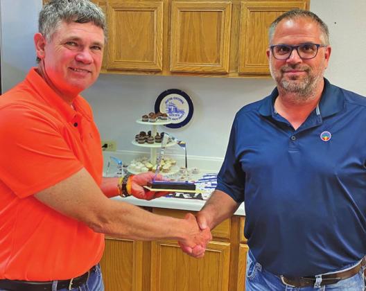 Mayor Chip Olson presents Jason Woinarowicz with parting gifts for his 14 years of service on the City Council. Photo submitted by Michael Larson