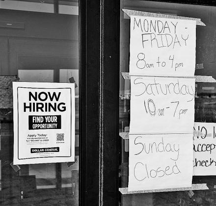 Recent photo of the entrance to Dollar General in Crosby plastered with hand written signs giving notice of variable hours due to a lack of staff. Photo courtesy of Cecile Wehrman, The Journal.