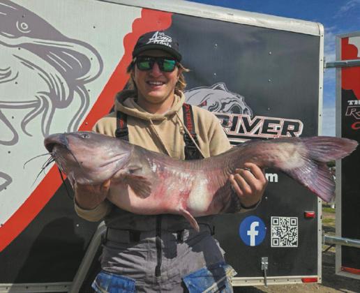 At 26.75 pounds, Zach Erickson, shows off the largest fish of the tournament. Photo by Rob Boll.