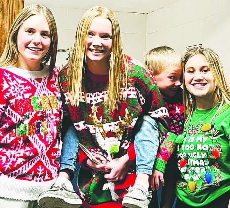Kiara Aasand, Easton Larson, Elliot and Claire Thompson pose in their ugly sweaters. Photo from Lauri Logsdon.
