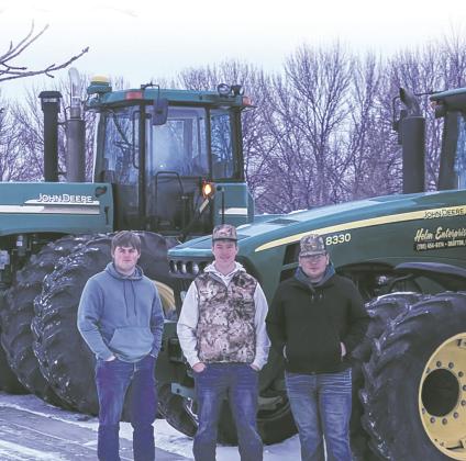 Ryan Corrik, Jaxon Wilson and Carlos Quezada stand with their tractors on Tractor Day. Submitted photo