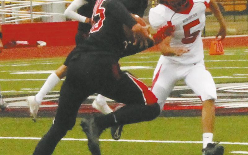 Defender Lucas De Souza chases down a White Shield ball carrier to prevent a first down. Photo by Jamie Rarick