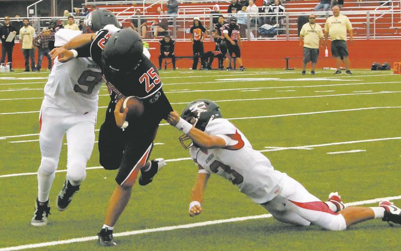 Mason Pollestad and Trenten Keena work together to bring down the White Shield quarterback. Photo by Jamie Rarick
