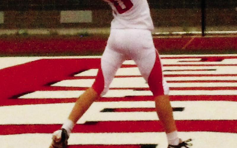 Leaping for the ball, Shawn Patterson makes a successful catch for an extra point conversion. Photo by Jamie Rarick