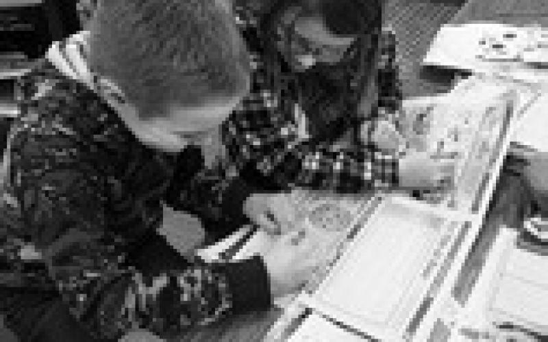 Connor Petersen and Ava Keysor, fourth graders at Kenmare Elementary, collaborate on activities in Kid Scoop News. Photo Terry Froseth, The Kenmare News.
