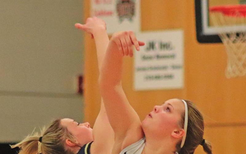 The season finally begins! Kasey Stegman and North Border’s Keira Moore fight for the ball in the opening tip of the 2020-2021 Girls Basketball Season. VNV Photo by Lesa Van Camp